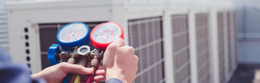 Hvac Tech Checking Pressure On Commercial Unit (1) Hvac Tech Checking Pressure On Commercial Unit (1)